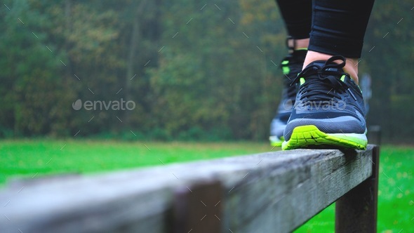 Balancing on a ledge railing to keep balance and fit healthy - Stock Photo - Images
