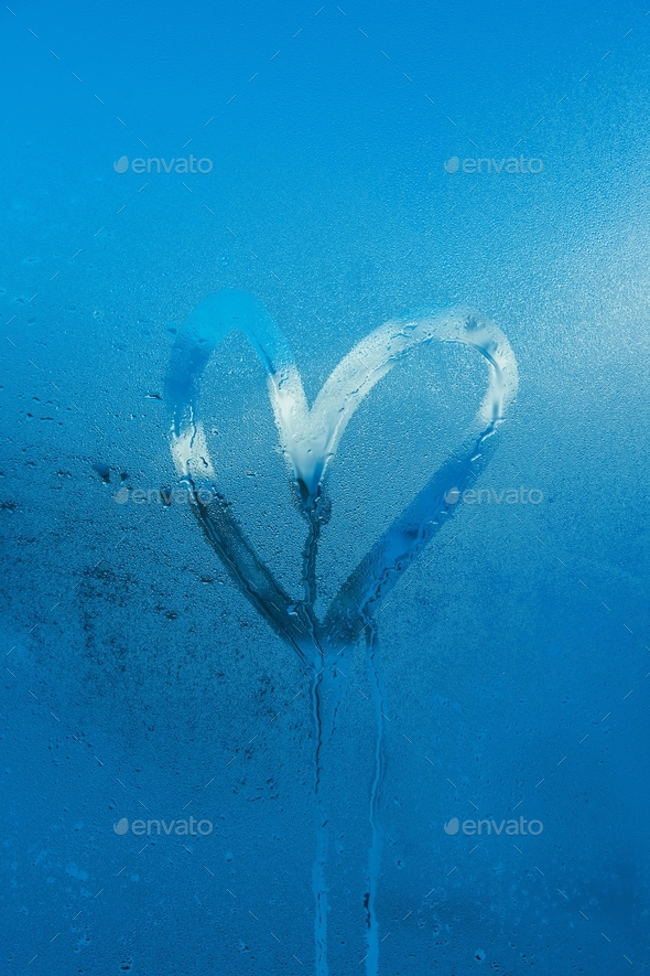 Blue heart shape condens drawing on window love romance romantic Stock