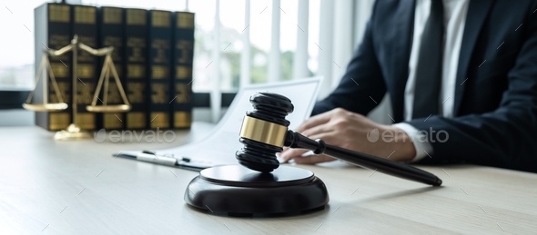 Counselor lawyer working on a documents and report of the important case and wooden gavel - Stock Photo - Images