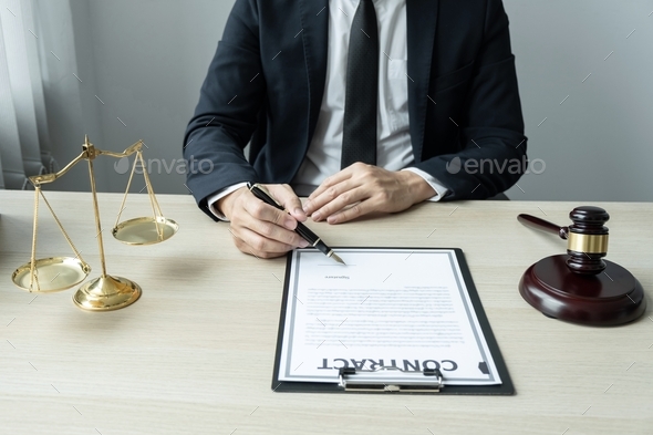 Counselor lawyer or notary working on a documents and report of the important case and wooden gavel - Stock Photo - Images