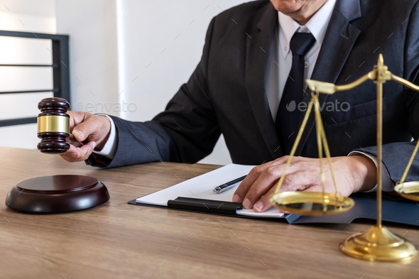lawyer or notary working on a documents and report of the important case and wooden gavel - Stock Photo - Images