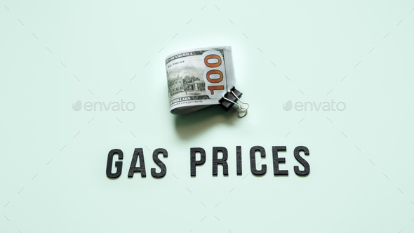 Gas prices, Energy crisis concept. Gasoline prices rising. Stack of dollar bills