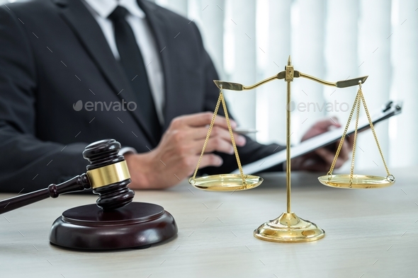 Male lawyer working with legal case document contract in office - Stock Photo - Images