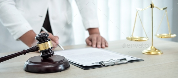 Female lawyer working with legal case document contract in office - Stock Photo - Images
