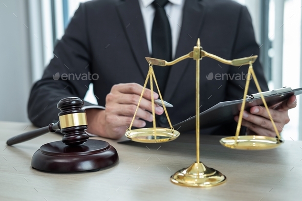 Male lawyer working with legal case document contract in office - Stock Photo - Images