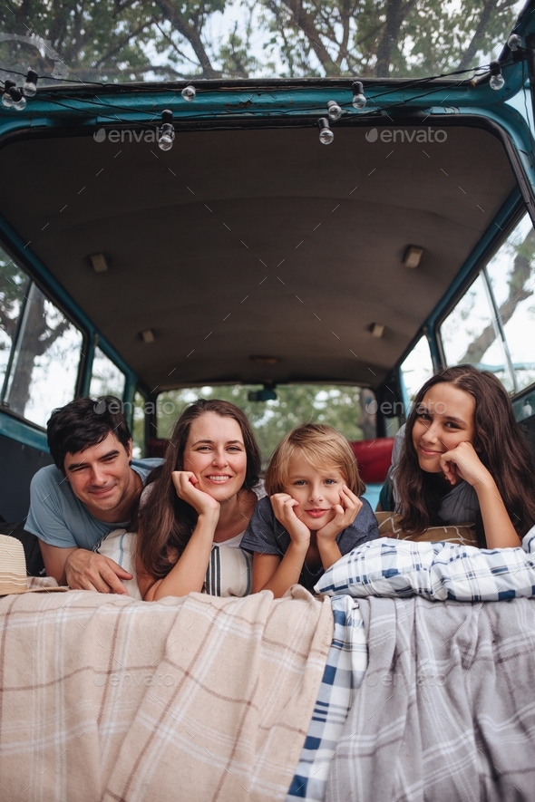 Happy family portrait in camping trailer