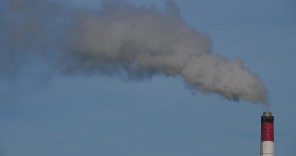 Smoke and air pollution from a incinerator chimney near Caen, Normandy, France. alt