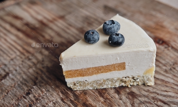 slice of gluten-free cake with sugar-free blueberries, close-up on a wooden background