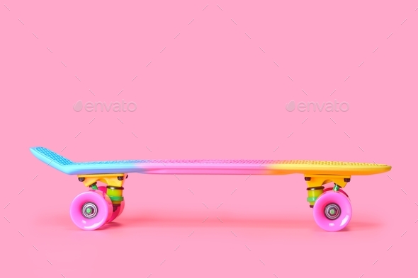 rainbow plastic Penny board skateboard isolated on pink background Stock Photo by