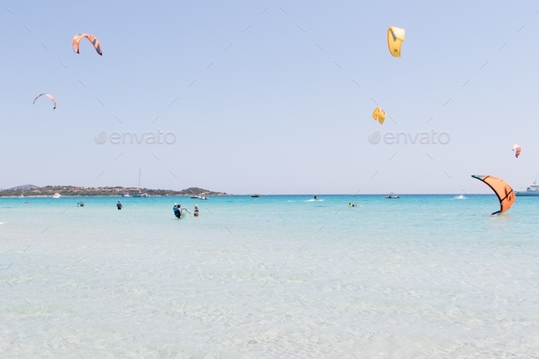 July 23, 2021: Kitesurf school in the crystal clear sea near the beach of La Cinta, Sardinia.