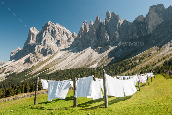 White clothes hung out to dry in the panorama of the Dolomites Odle mountains