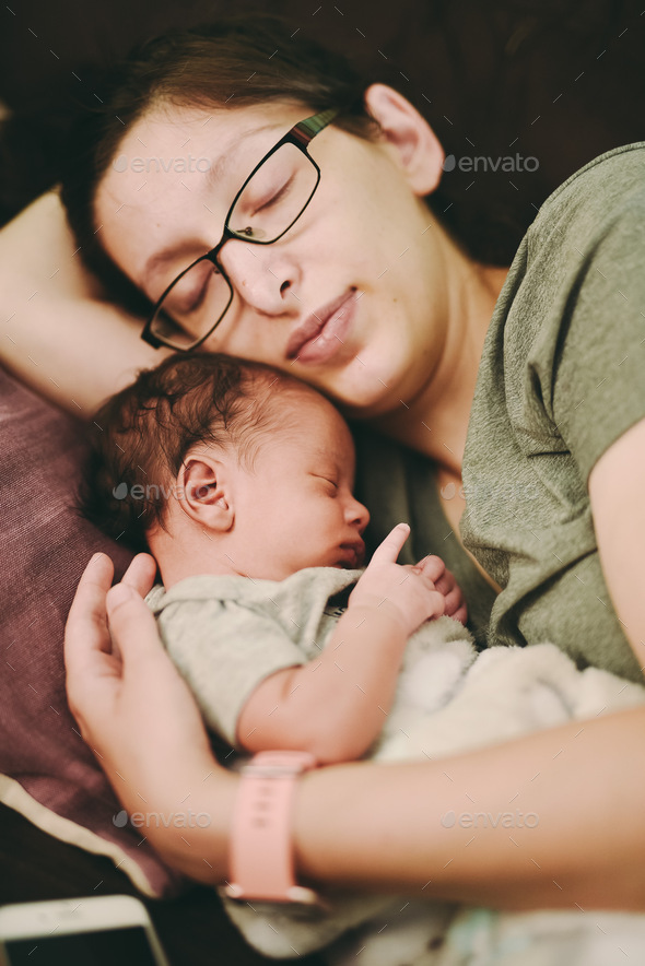 Mother sleeping on couch with baby boy Stock Photo by R_Hamilton
