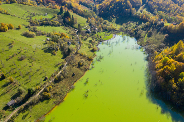 Aerial view of green mine waters from a copper mine flooding natural habitat