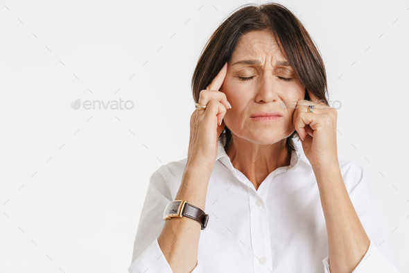 Mature Woman With Headache Frowning While Rubbing Her Temples Stock