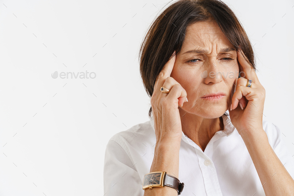 Mature Woman With Headache Frowning While Rubbing Her Temples Stock