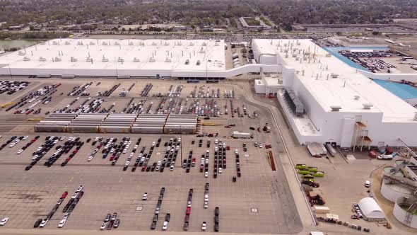 Delivery Trucks And Cars Parked At The Parking Area Of FCA Stellantis Assembly Plant In Sterling Hei alt