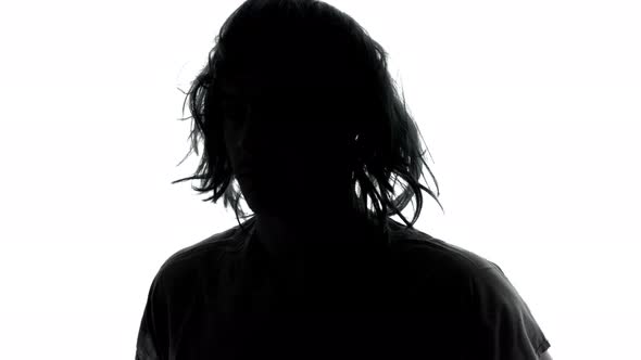 Mysterious Man in Silhouette with Long Messy Hairs