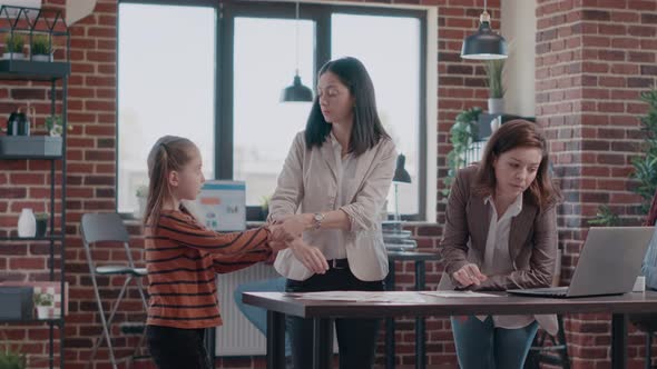 Single Mom Trying to Work with Colleague While Daughter Disturbing Work alt
