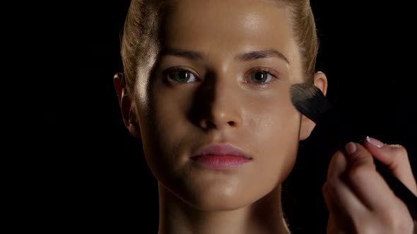 Professional Makeup. Brushwork on the Face. Black. Closeup alt