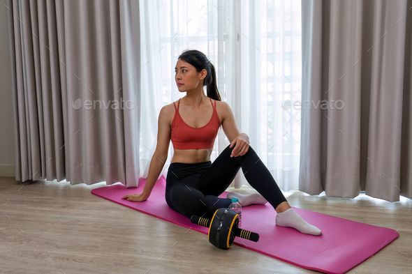 Beautiful lady meditation pilates yoga muscle exercise in the leaving room and drink water