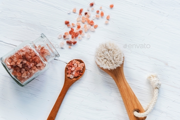 Natural cosmetic himalayan salt, face brush, wooden spoon on white table. Zero waste, Plastic free.