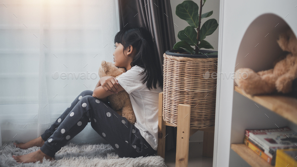 lonely little girl hugging toy, sitting at home alone, upset unhappy child waiting for parents,
