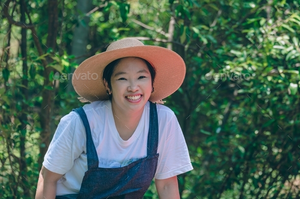 Asian woman smiling and looking at camera while ecotourism in mangrove forest at natural parkland