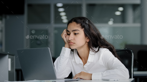 Sad bored lazy young woman typing on laptop tired unmotivated businesswoman office worker feels