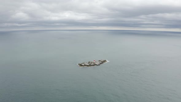 Aerial capture of The Muglins Lighthouse during a cloudy day alt