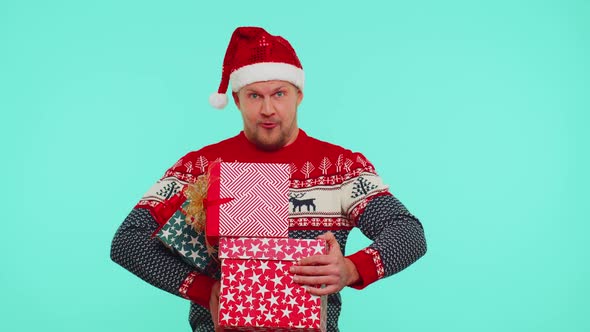 Man in Christmas Red Sweater Santa Hat Smiling Holding Many Gift Boxes New Year Presents Shopping alt