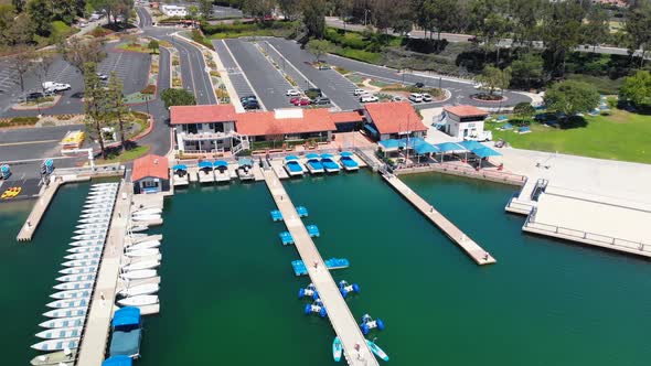 Aerial fly over of the docks with blue boats on community lake mission viejo alt