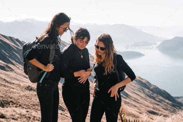 three caucasian girls dressed in black t-shirts black pants and backpack on their back standing
