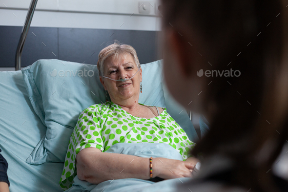 Grandmother being visited by granddaughter at geriatric hospital - Stock Photo - Images