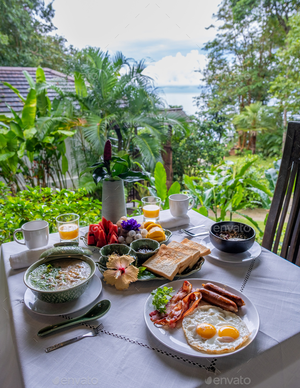 breakfast table in a tropical garden in Thailand, breakfast with Thai food ,fruit and eggs