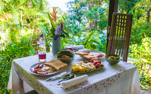 breakfast table in a tropical garden in Thailand, breakfast with Thai food ,fruit and eggs