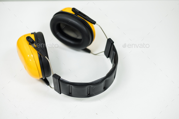Yellow black ear muffs for ear protection, PPE, safety work concept.