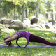 Young woman doing yoga exercises on the outdoor lawn. - PhotoDune Item for Sale
