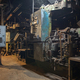 An old industrial machine in a stopped factory for the production of cast iron car parts - PhotoDune Item for Sale