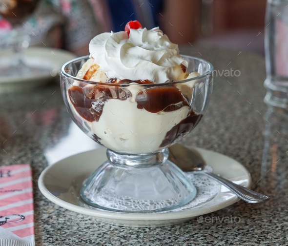 Hot fudge sundae with whipped cream and a cherry on top