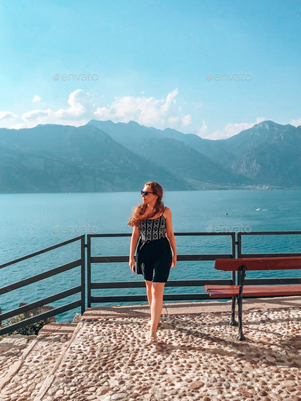 Beautiful blue landscape, water, mountains, lake, walking woman, portrait, travel, nature, tourism