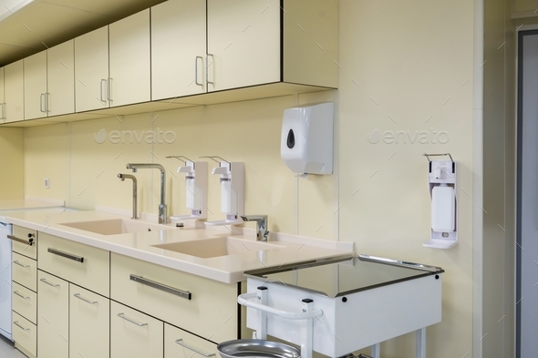 elbow soap and antiseptic dispenser or sanitizer wall mounted for hand disinfection and water tap