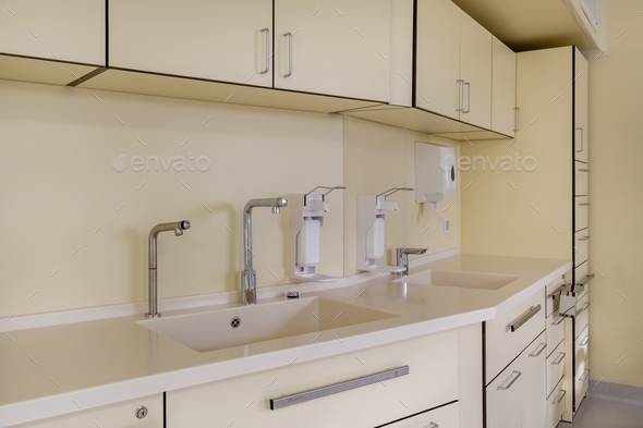 elbow soap and antiseptic dispenser or sanitizer wall mounted for hand disinfection and water tap