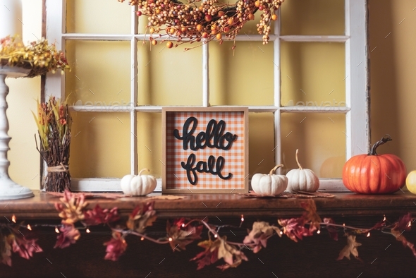 Hello fall sign and pumpkins on the fireplace mantel - cozy home decor