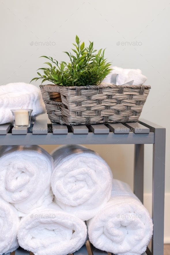 Fluffy white towels rolled and stacked in the bathroom Stock Photo by