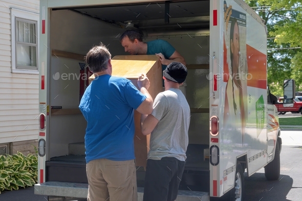 People loading a truck on moving day - Stock Photo - Images