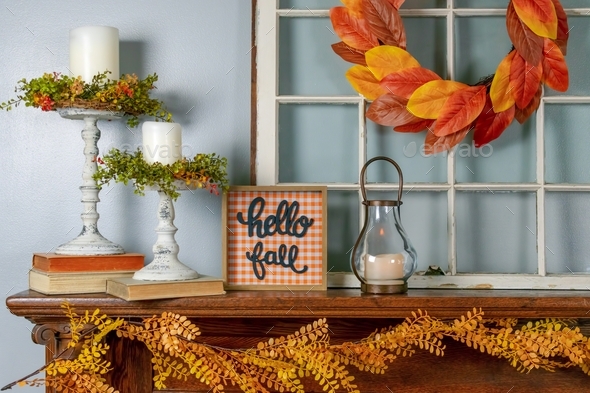 Hello fall sign on fireplace mantel decorated for autumn