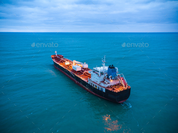 Aerial view oil ship tanker carrier oil on the sea at sunrise