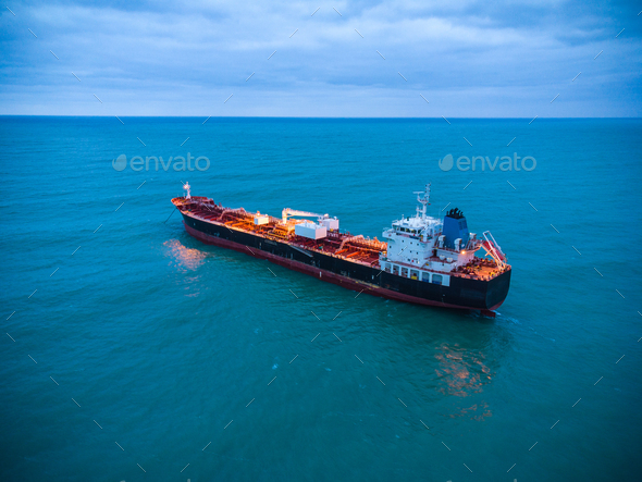 Aerial view oil ship tanker carrier oil on the sea at sunrise