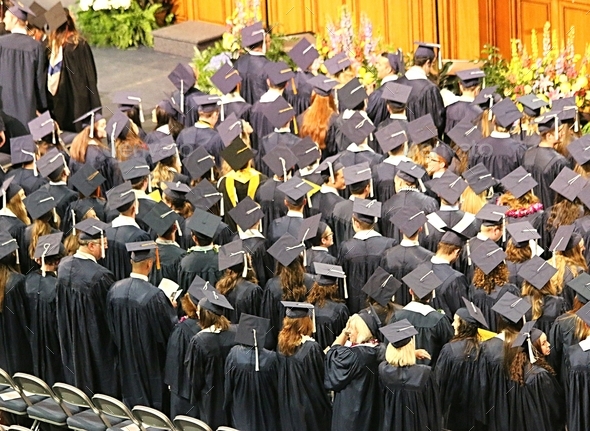 Crowd of graduates from behind at a university graduation ceremony ...