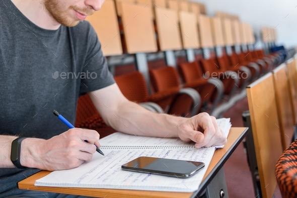 Man student in empty classroom - Stock Photo - Images